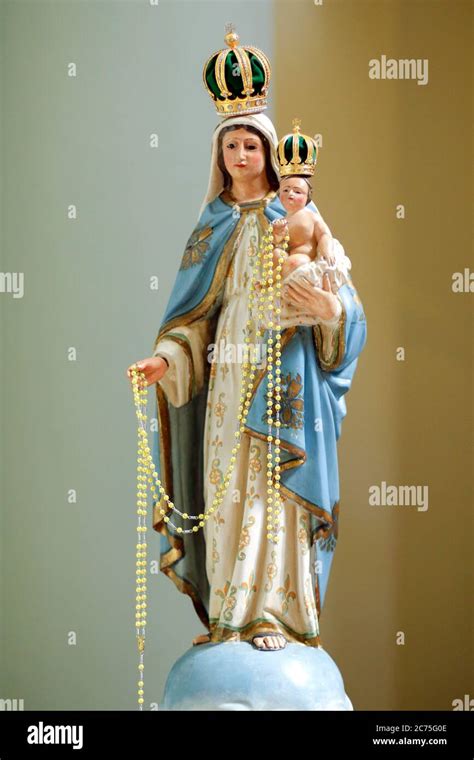 Photo of a rosary and a statue of Mary
