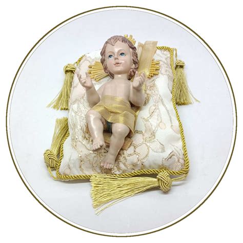 Statua di Gesù Bambino con lacrime sul cuscino