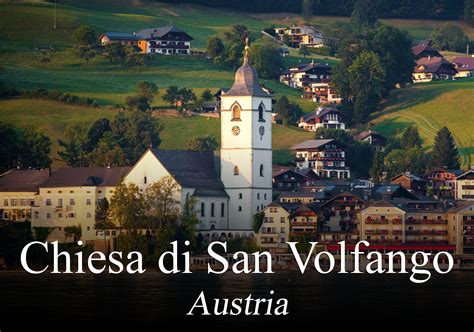 Veduta panoramica della Chiesa Parrocchiale di San Volfango a Redagno, con il campanile e il paesaggio montano circostante