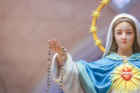 Thematic photo of the Virgin Mary, possibly with a rosary, or a depiction of spiritual warfare against evil