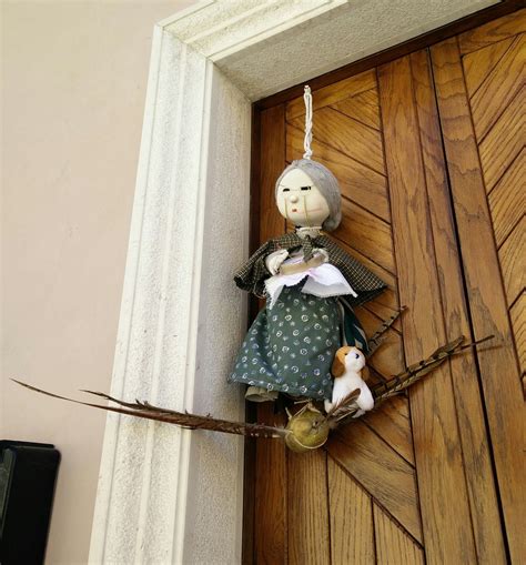 Foto di una Quarantana, bambola di pezza appesa tra due balconi, in un vicolo di Martina Franca