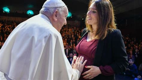 Foto di un sacerdote che benedice una donna incinta in una celebrazione comunitaria