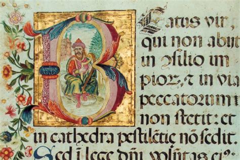Foto della Bibbia Aprutina aperta, con evidenziate le miniature tabellari e i capilettere istoriati