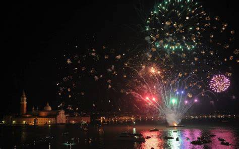 Veduta notturna del Bacino di San Marco durante la Festa del Redentore con fuochi d'artificio e barche illuminate