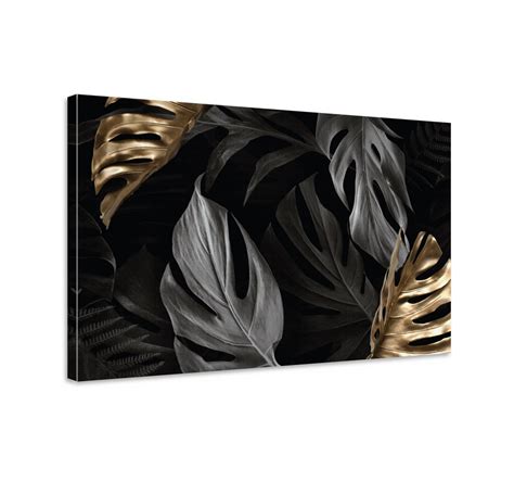 Immagine di un quadro moderno con foglie tropicali e finiture oro