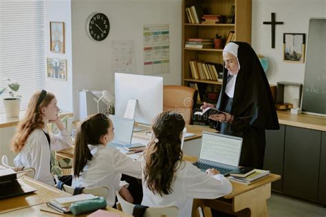 Thematic photo of a nun working on a computer or a book open on a tablet, symbolizing online spiritual guidance