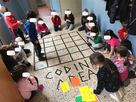 Bambini che partecipano a attività di coding unplugged con schede e giochi di logica