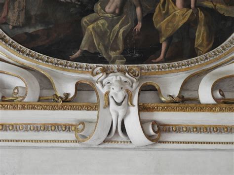 Altare intagliato barocco con dettagli decorativi, elementi antropomorfi e teste alate