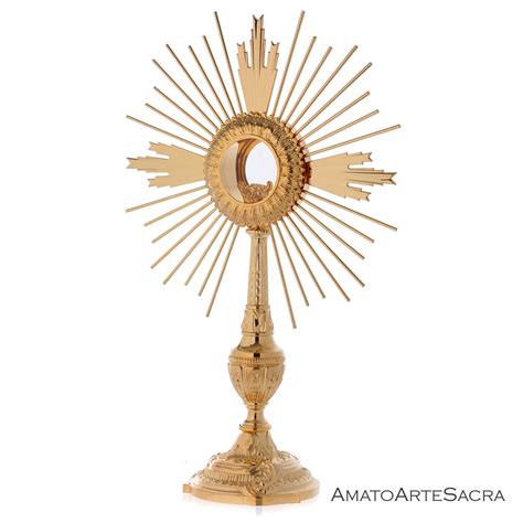 Icona stilizzata di un ostensorio con raggi di luce che si irradiano