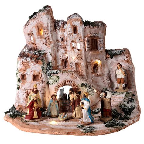 Scena della Natività con figure in terracotta in un paesaggio tradizionale