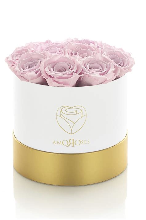 Una composizione di rose stabilizzate Amoroses in una cappelliera rifinita a mano, con particolari dorati.