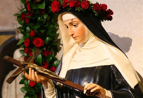 Illustrazione storica o rappresentazione iconografica di Santa Rita con le rose e il crocifisso
