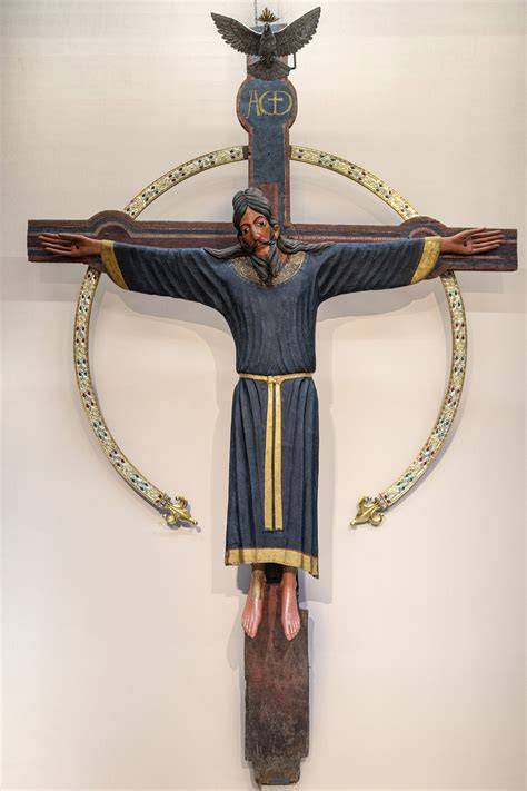 Dettaglio ravvicinato del volto di San Pietro e della sua postura sulla croce, evidenziando il lavoro cromatico e i pentimenti del maestro.