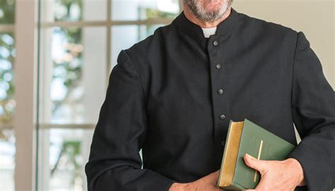 foto di un sacerdote che benedice una famiglia multiculturale