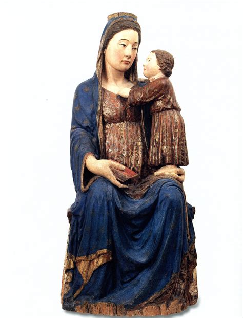 Scultura della Madonna con un bambino che prega ai suoi piedi