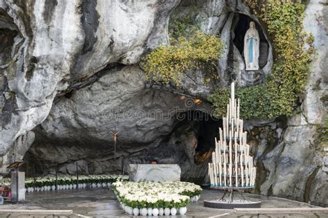 The Grotto of Massabielle at the Sanctuary of Lourdes with pilgrims praying