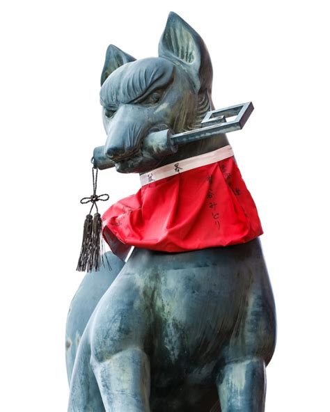 Statua di volpe (kitsune) con una chiave in bocca presso il Santuario Fushimi Inari Taisha