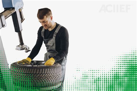 Un tecnico gommista che utilizza attrezzature moderne per riparare un pneumatico danneggiato, mostrando attenzione ai dettagli.