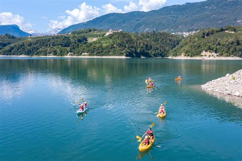 Lago di Lourdes con attività acquatiche e montagne sullo sfondo
