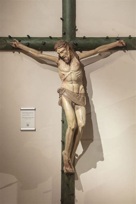 Dettaglio del Cristo crocifisso di Grünewald, evidenziando le ferite e le mani in spasmo