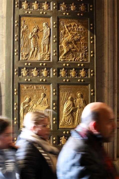 Thematic photo of the Holy Door in St. Peter's Basilica with pilgrims passing through