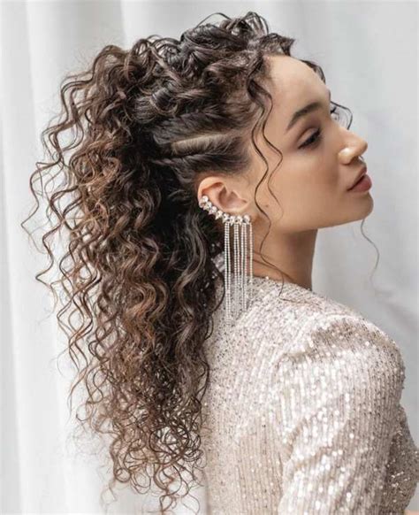 Tina Kunakey con un semi-raccolto vaporoso su capelli ricci.